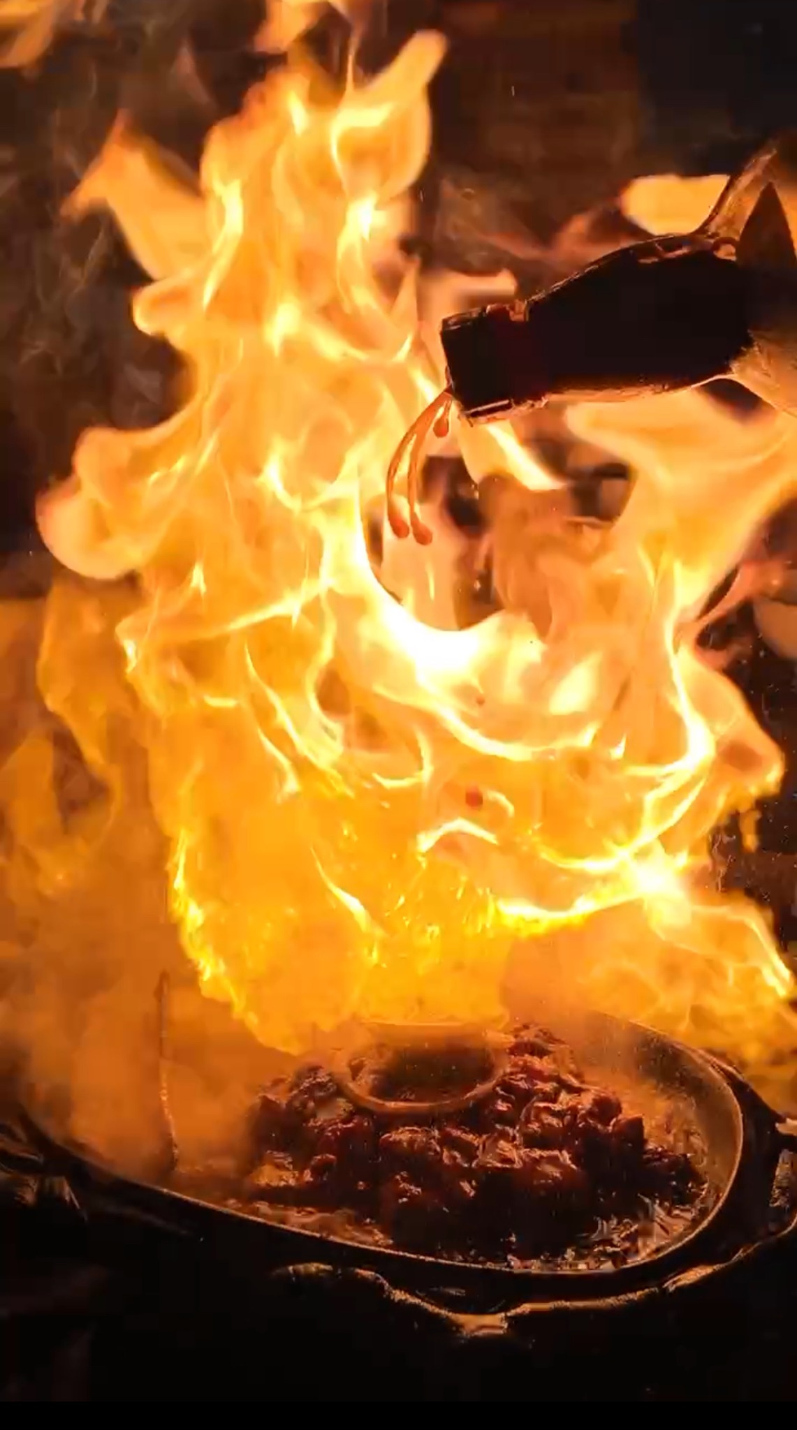 Japanese-style steak being finished over a dramatic flame at I'm Hungry 454 in Phnom Penh